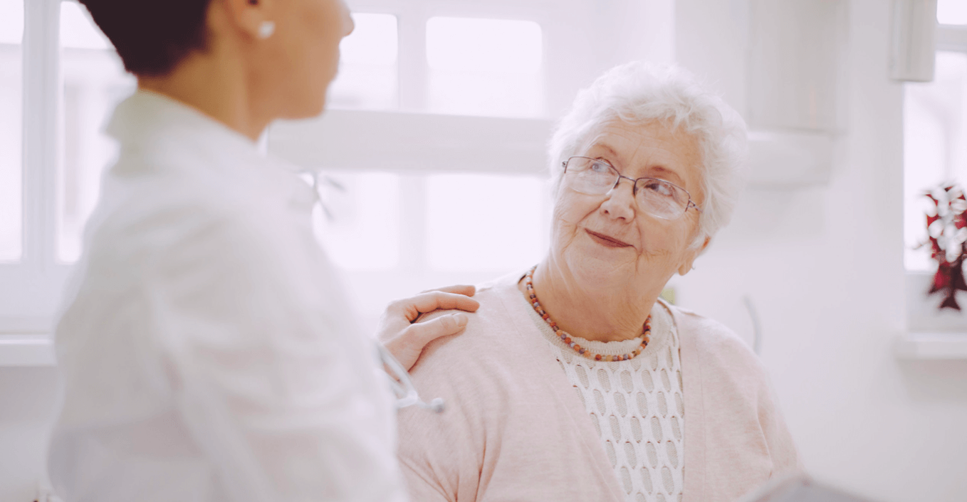 A clinician speaks to an elderly patient. An ACP program should be an ongoing, patient-centered conversation.